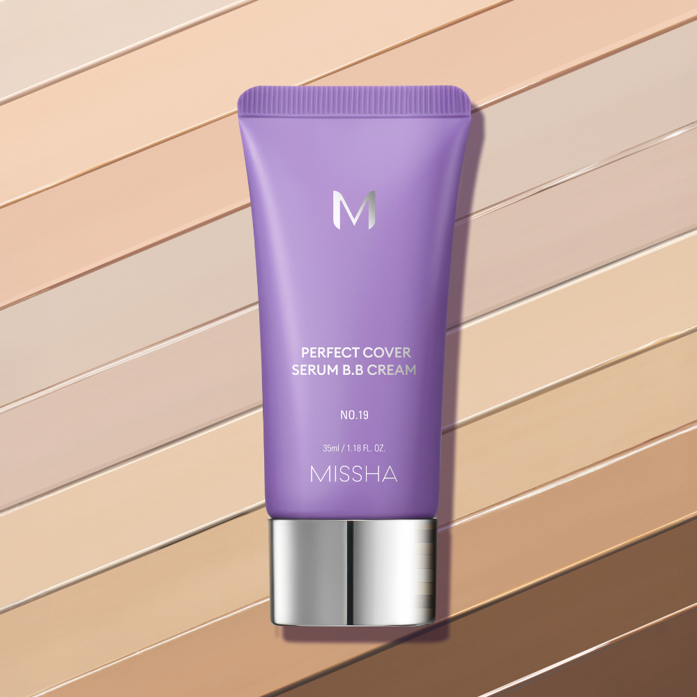 A lavender-colored tube of Missha Perfect Cover Serum B.B. Cream against a background of diagonal stripes in various skin tone shades. A lavender-colored tube of Missha Perfect Cover Serum B.B. Cream against a background of diagonal stripes in various skin tone shades.