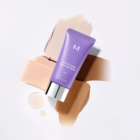 A tube of Missha Perfect Cover Serum B.B. Cream with swatches of different shades and two drops of serum on a white background. A tube of Missha Perfect Cover Serum B.B. Cream with swatches of different shades and two drops of serum on a white background.