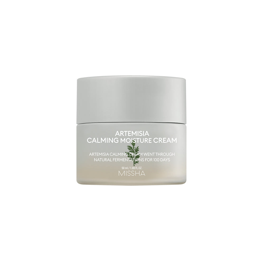 A jar of Missha Artemisia Calming Moisture Cream with white and green labeling, indicating it is a skin care product. A jar of Missha Artemisia Calming Moisture Cream with white and green labeling, indicating it is a skin care product.