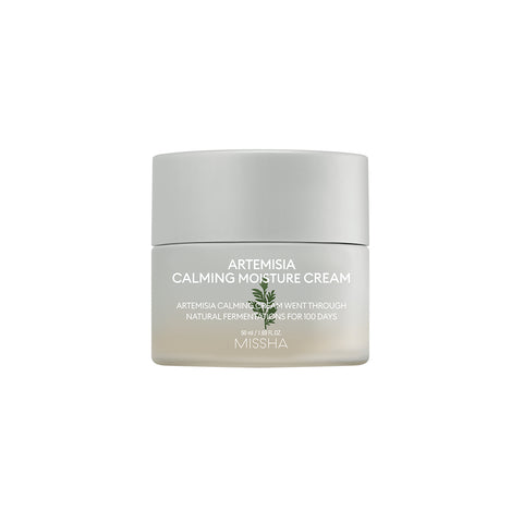 A jar of Missha Artemisia Calming Moisture Cream with white and green labeling, indicating it is a skin care product. A jar of Missha Artemisia Calming Moisture Cream with white and green labeling, indicating it is a skin care product.