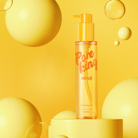 Bright yellow promotional image of A’pieu Pore King Minji Cleansing Oil, featuring the transparent golden bottle with pump surrounded by floating yellow spheres on a matching yellow background, highlighting a fresh and vibrant aesthetic. Bright yellow promotional image of A’pieu Pore King Minji Cleansing Oil, featuring the transparent golden bottle with pump surrounded by floating yellow spheres on a matching yellow background, highlighting a fresh and vibrant aesthetic.