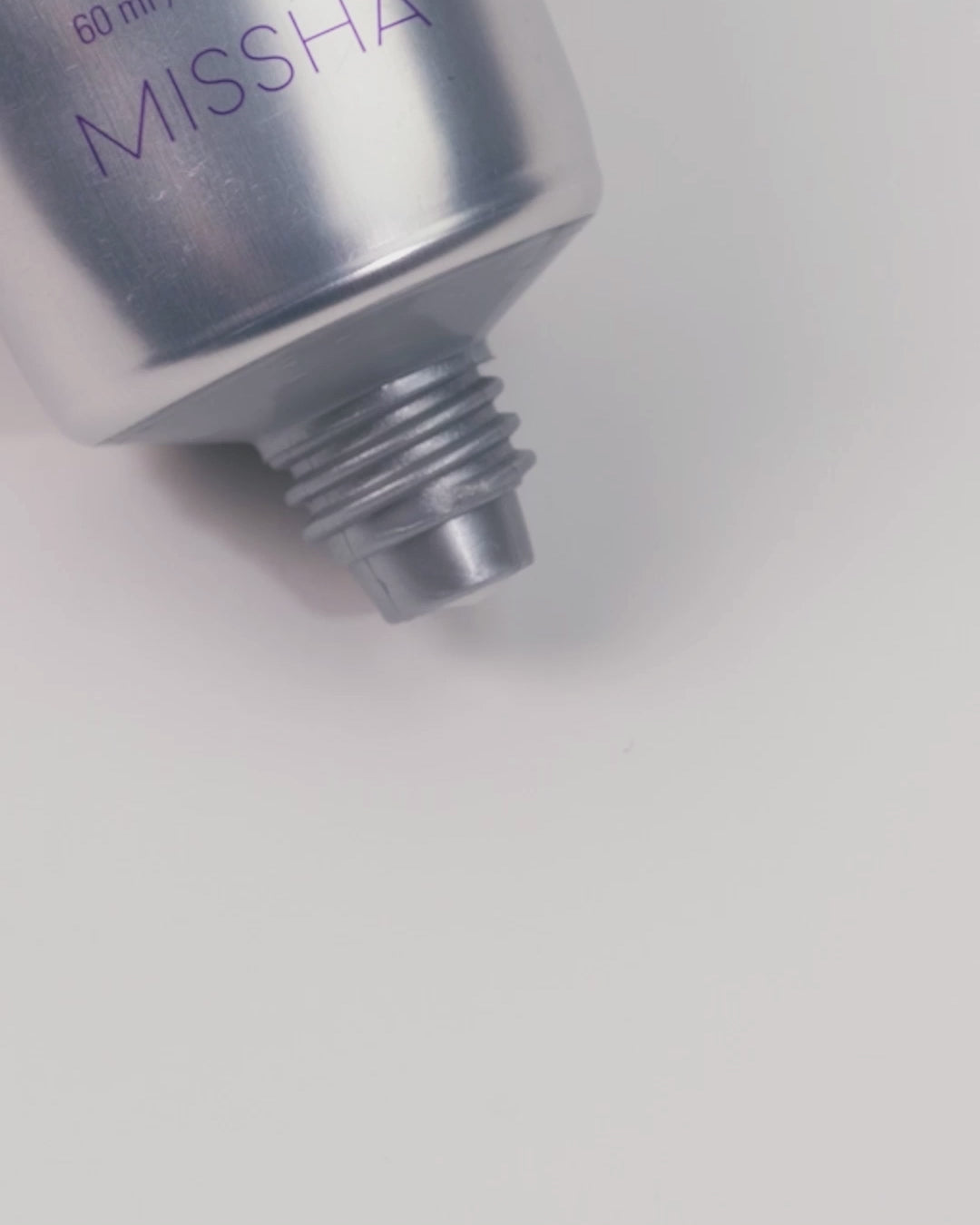 Close-up video showing the Missha Time Revolution Retinol 500IU Cream being gently squeezed from the tube, revealing a thick, white cream exiting the nozzle, demonstrating the controlled dispensing and rich texture of the anti-wrinkle Retinol cream Close-up video showing the Missha Time Revolution Retinol 500IU Cream being gently squeezed from the tube, revealing a thick, white cream exiting the nozzle, demonstrating the controlled dispensing and rich texture of the anti-wrinkle Retinol cream