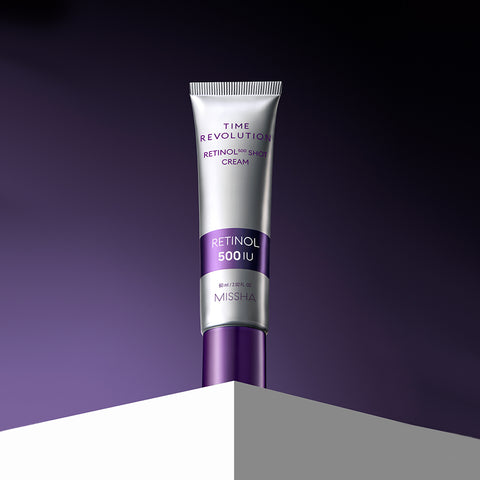 Studio shot of the Missha Time Revolution Retinol 500IU Cream in a silver tube with a deep purple cap, standing upright on a white block against a gradient purple background, emphasizing its sophisticated anti-aging skincare benefits. Studio shot of the Missha Time Revolution Retinol 500IU Cream in a silver tube with a deep purple cap, standing upright on a white block against a gradient purple background, emphasizing its sophisticated anti-aging skincare benefits.