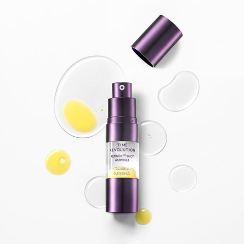 MISSHA Time Revolution Retinol 0.5 Shot Ampoule bottle with its cap off, surrounded by drops of yellow and clear serum, displayed on a clean white background to highlight its anti-aging formula and lightweight texture. MISSHA Time Revolution Retinol 0.5 Shot Ampoule bottle with its cap off, surrounded by drops of yellow and clear serum, displayed on a clean white background to highlight its anti-aging formula and lightweight texture.