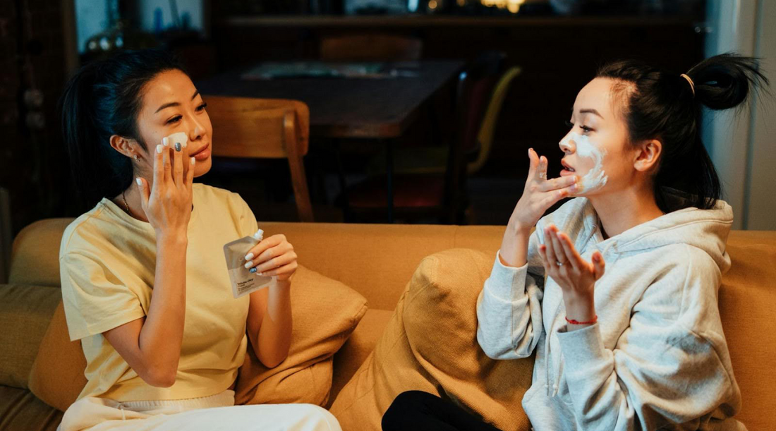 Two Women Applying Moisturizer to their Faces