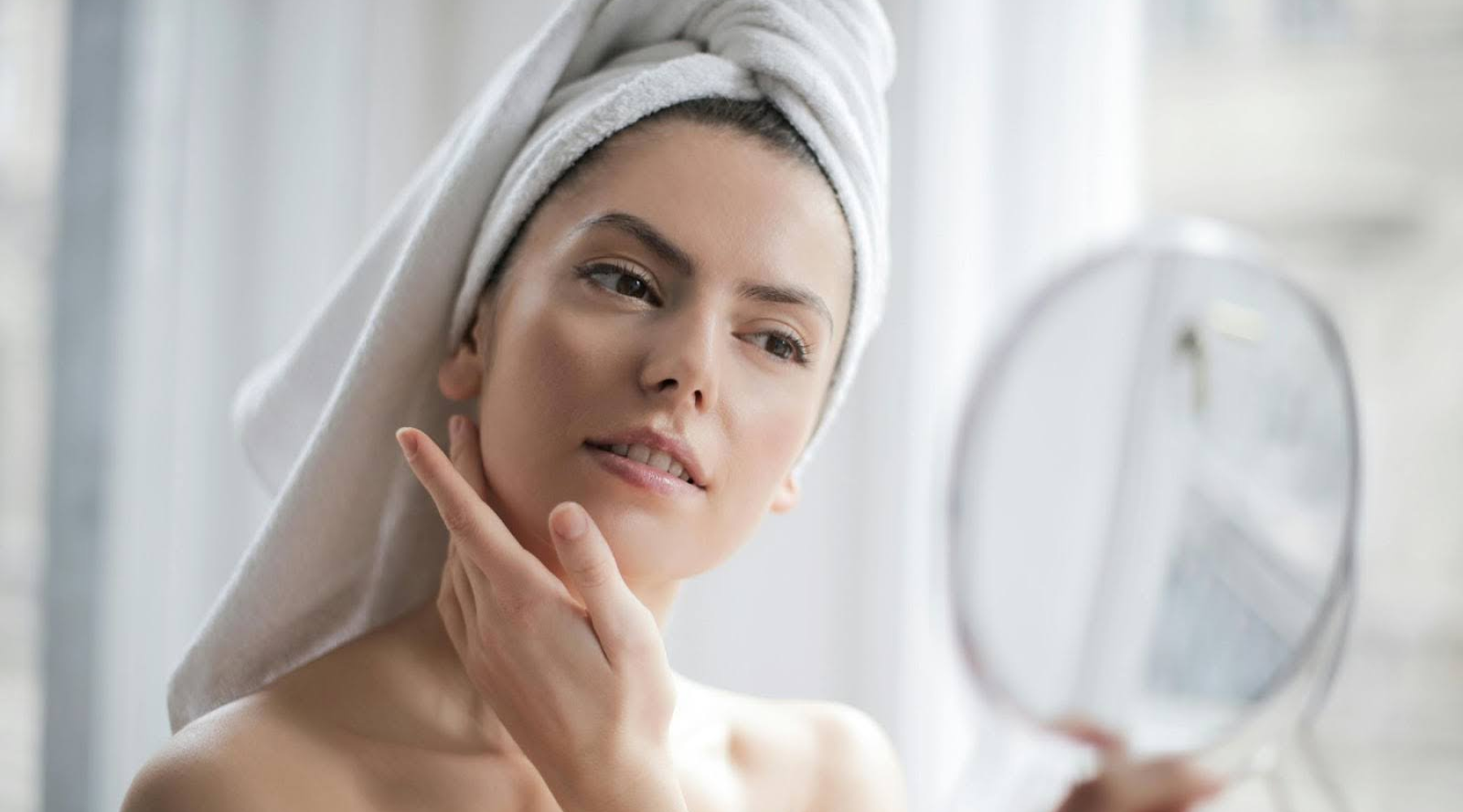 Woman Looking in the Mirror with Towel on Head