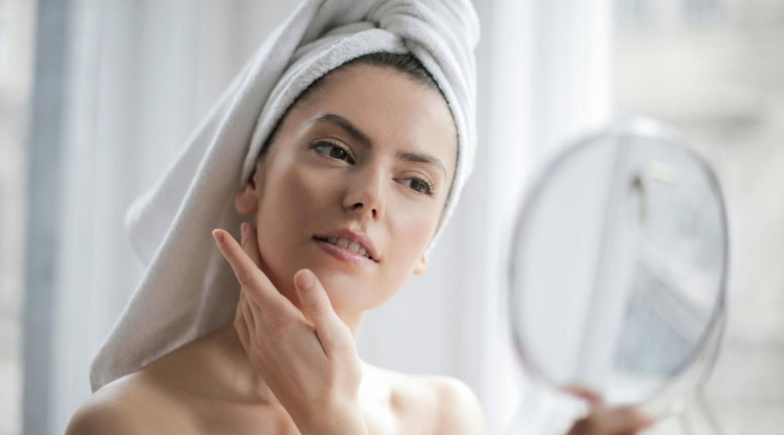 Woman Looking in the Mirror with Towel on Head