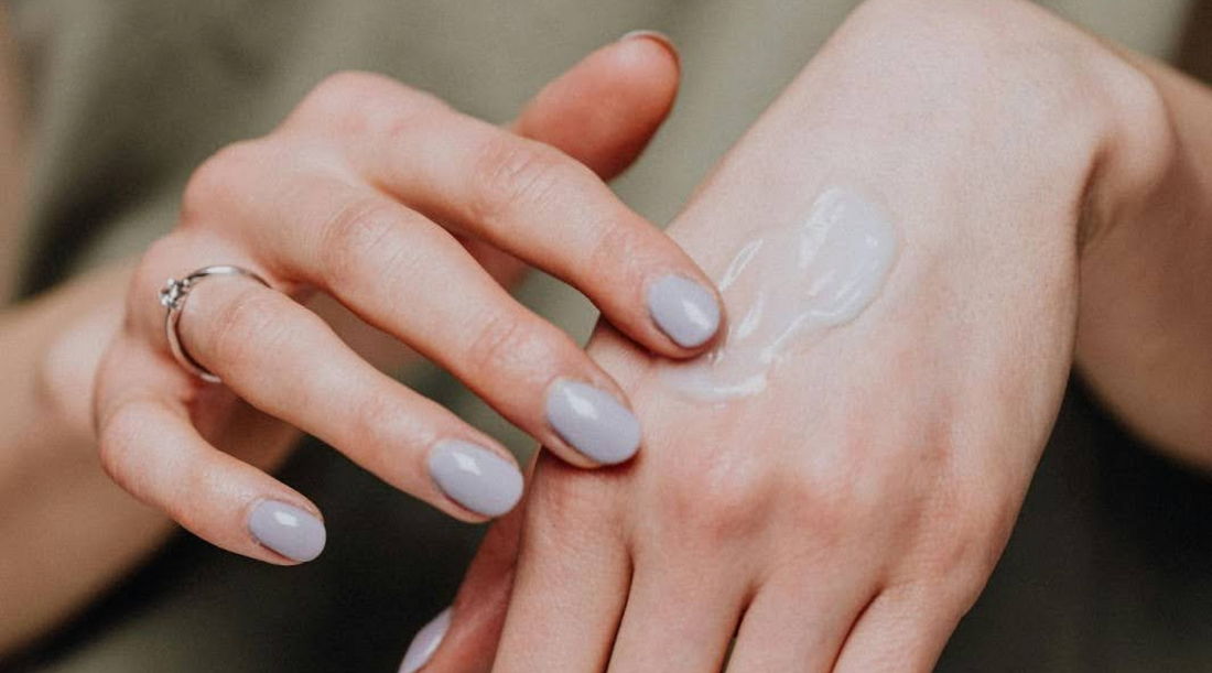 Woman applying moisturizer