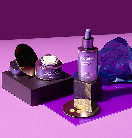 Two purple skincare products a cream jar and serum bottle elegantly displayed against a bold purple backdrop.