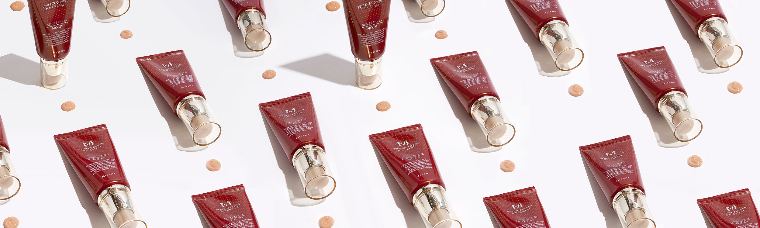 Multiple tubes of Missha Perfect Cover BB Cream arranged neatly with beige product swatches on a white background.