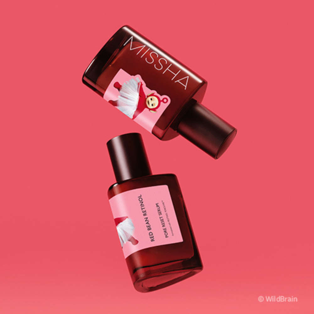 Two brown glass ampoules of MISSHA Red Bean Retinol Pore Reset Serum floating against a pink background, featuring a Teletubbies character illustration on the label.