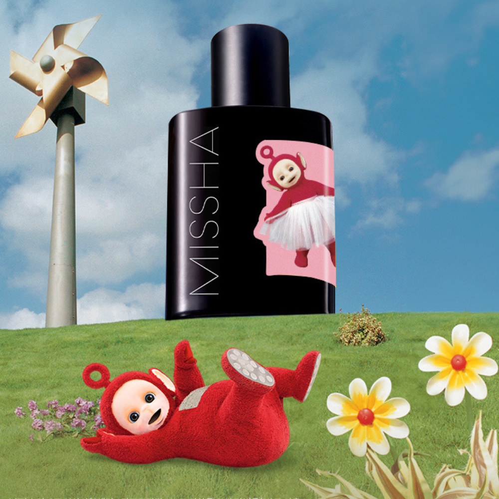 Black MISSHA ampoule bottle with a teletubbies  label on a grassy hill with flowers and a windmill.