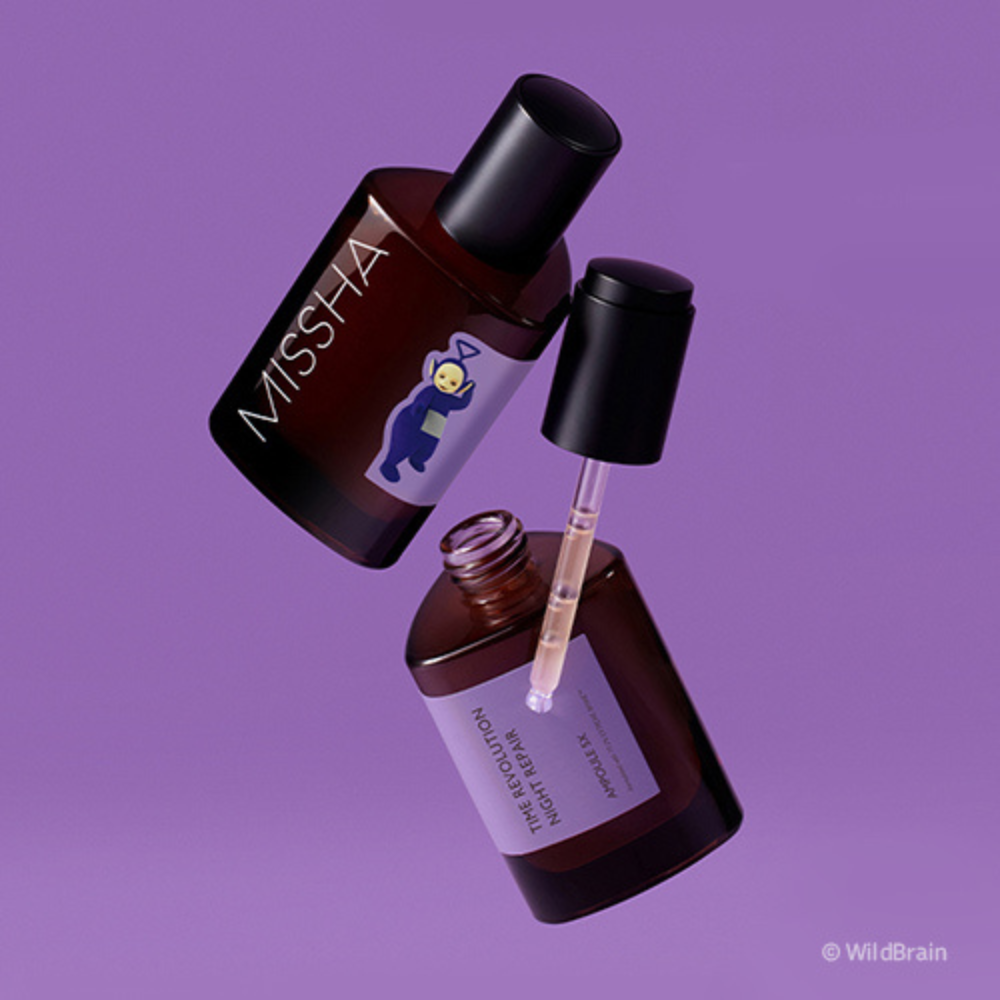Two brown glass ampoules of MISSHA Time Revolution Night Repair Ampoule floating against a purple background, featuring a Teletubbies character illustration on the label.