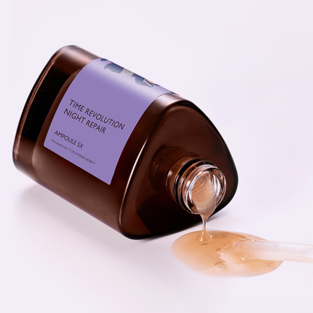 Skincare bottle labeled 'Time Revolution Night Repair' with liquid spilling out on a light background