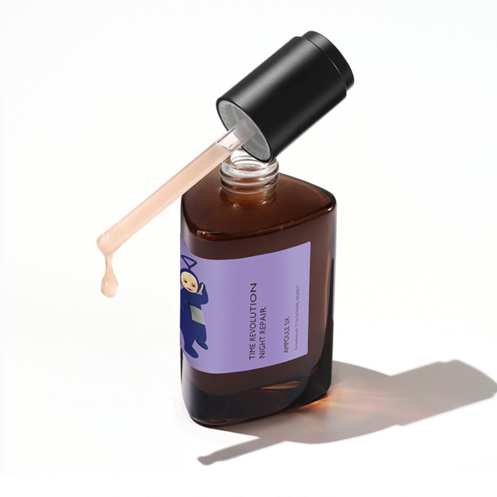 MISSHA Time Revolution Night Repair Ampoule bottle with a dropper dispensing serum, featuring a Teletubbies character on the purple label.