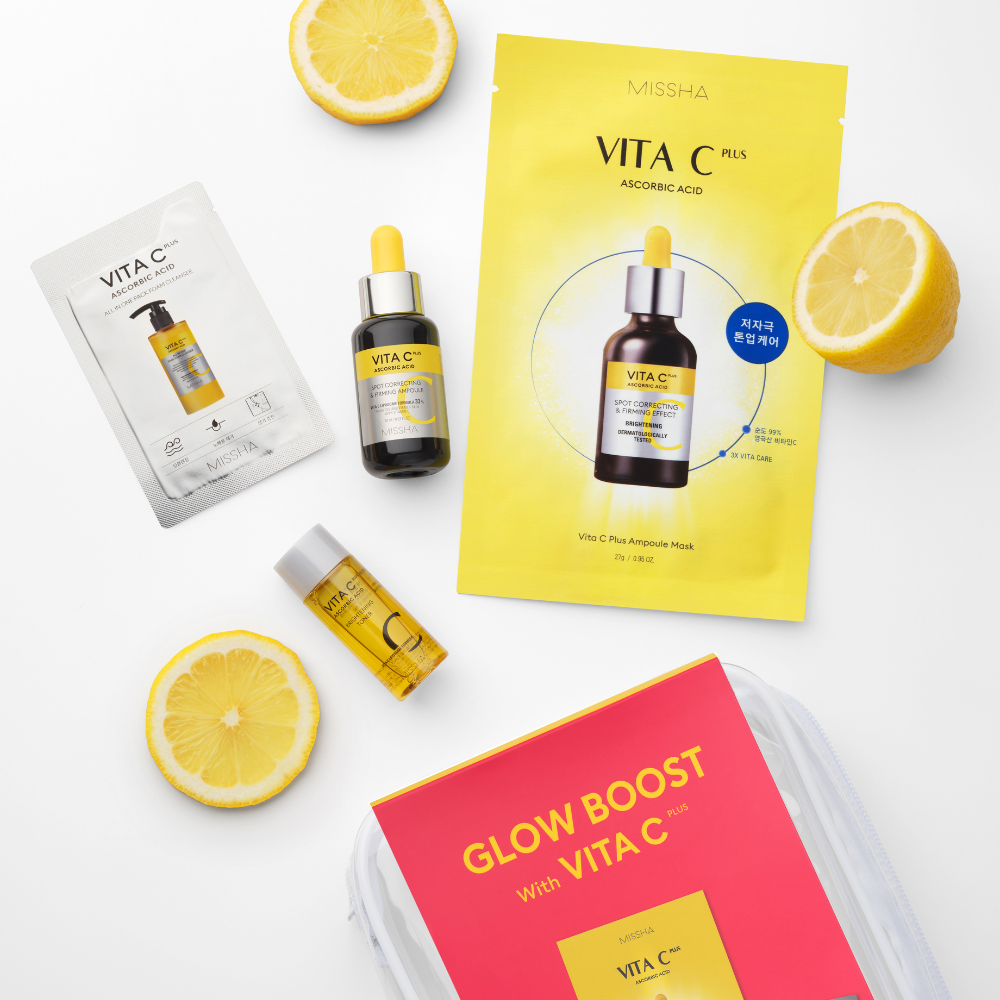 Skincare products with lemon slices on a white background, featuring Missha Vita C Plus packaging.