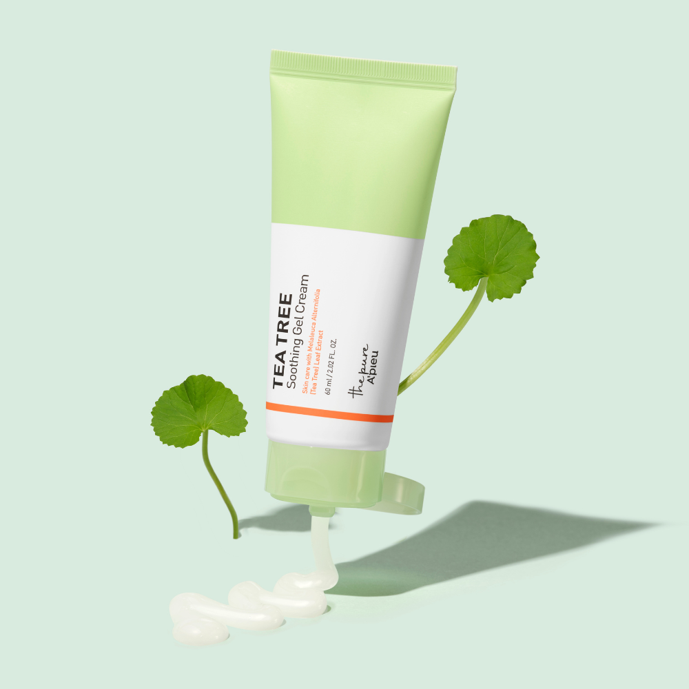 Tube of tea tree cream with leaves on a light green background