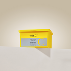 Yellow box of Missha Vita C sheet mask on a beige background