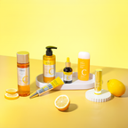 A collection of skincare products from Missha's Vita C Brightening K-Beauty Skincare Routine Kit, displayed on a yellow background. Products include a bubble foam cleanser, a brightening toner, a spot correcting ampoule, an eraser toning cream, an ampoule balm stick, and a sunscreen stick.