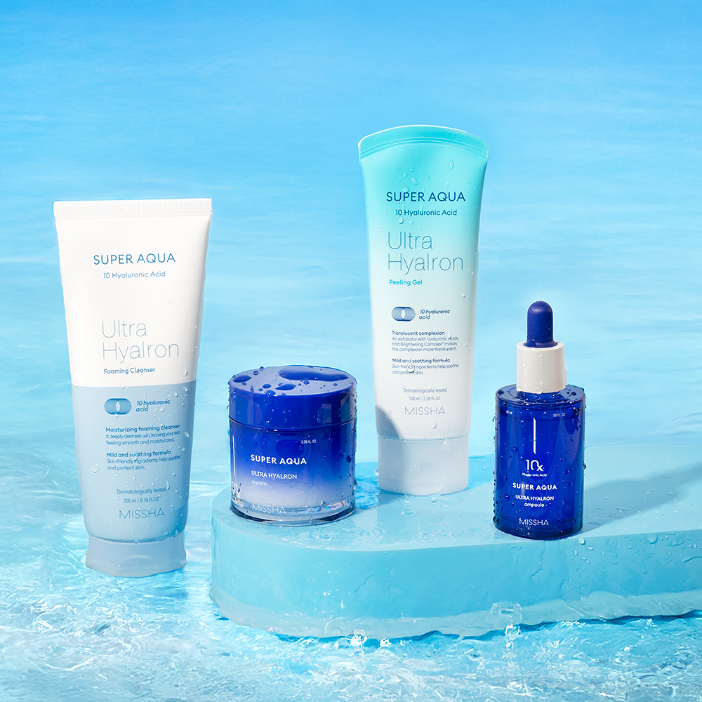 A collection of K-beauty skincare products displayed on a water-themed backdrop, including a cleansing foam, peeling gel, ampoule, and cream.