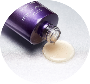 Close-up of a purple dropper bottle spilling creamy light serum with fine glitter particles onto a clean white surface.
