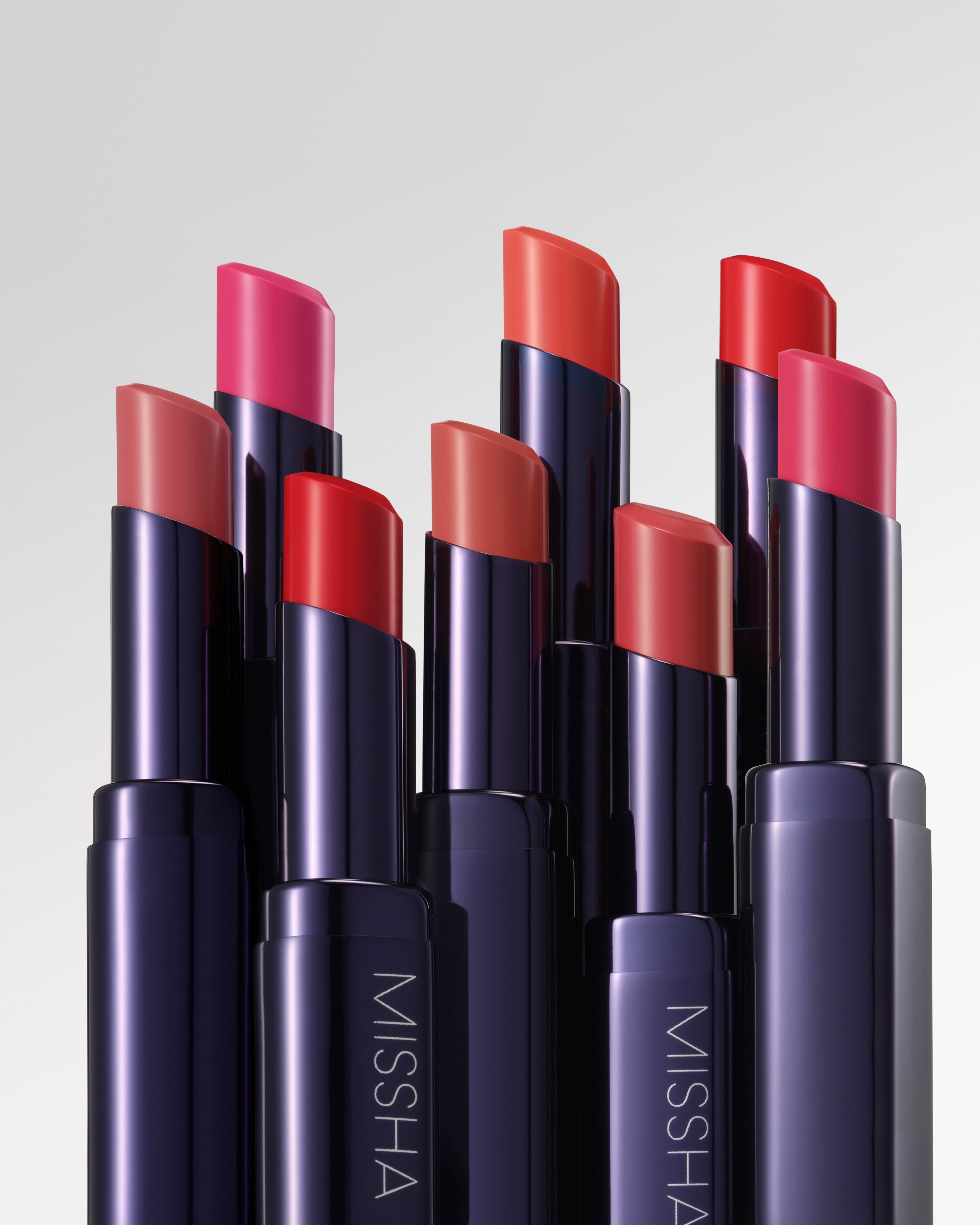 A collection of MISSHA Dewy Rouge lipsticks in various shades, displayed in their tubes.