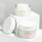 MISSHA Time Revolution The First Essence Pads in sleek frosted jars with white lids, displayed on minimalist white blocks for a clean and modern aesthetic.