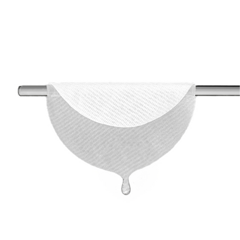 Close-up of a saturated essence pad hanging from a clear rod, with a drop of liquid dripping from the bottom, emphasizing its moisture-rich texture.