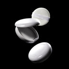 A dynamic shot of two Missha Airy Pot Pressed Powder Pact compacts and a soft white puff applicator against a black background. One compact is closed, and the other is open, displaying the interior and the MISSHA-branded powder puff, highlighting the K-beauty finishing powder and its packaging components.