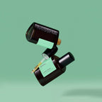 A black and green bottle of Missha Time Revolution Artemisia Ampoule with a dropper, set against a green background.