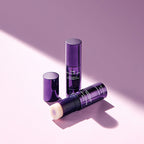 MISSHA Time Revolution Night Repair Ampoule Balm sticks in sleek purple packaging, one opened to reveal the balm texture, placed stylishly on a soft lavender background with gentle lighting and shadows.
