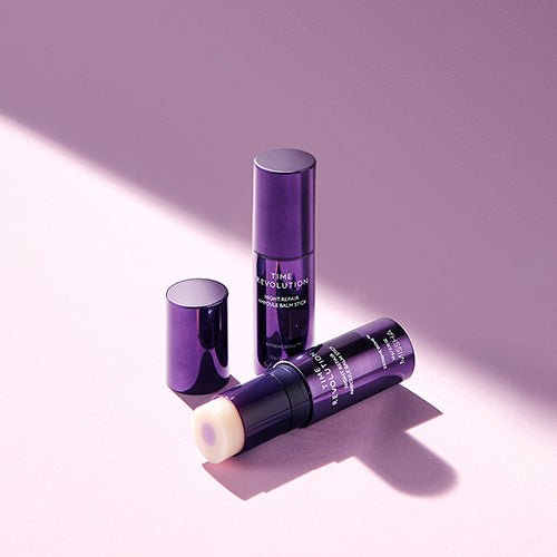 MISSHA Time Revolution Night Repair Ampoule Balm sticks in sleek purple packaging, one opened to reveal the balm texture, placed stylishly on a soft lavender background with gentle lighting and shadows.