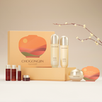 A Chogongjin Geumsul Nourishing Holiday Gift Set containing a variety of skincare products displayed in front of a box with a full moon and mountain design. Products include bottles and containers of various sizes, facial pads, and a mini facial essence.