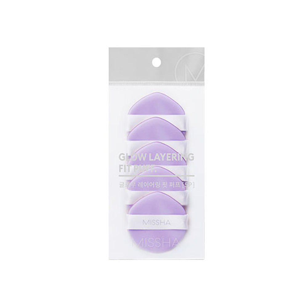 A pack of five purple Missha glow layering puff makeup puffs, packaged in a clear plastic bag with a hanging header.