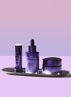 MISSHA Time Revolution Night Repair skincare trio displayed on a sleek tray against a purple gradient background, featuring the ampoule, cream, and eye serum in matching deep violet packaging.