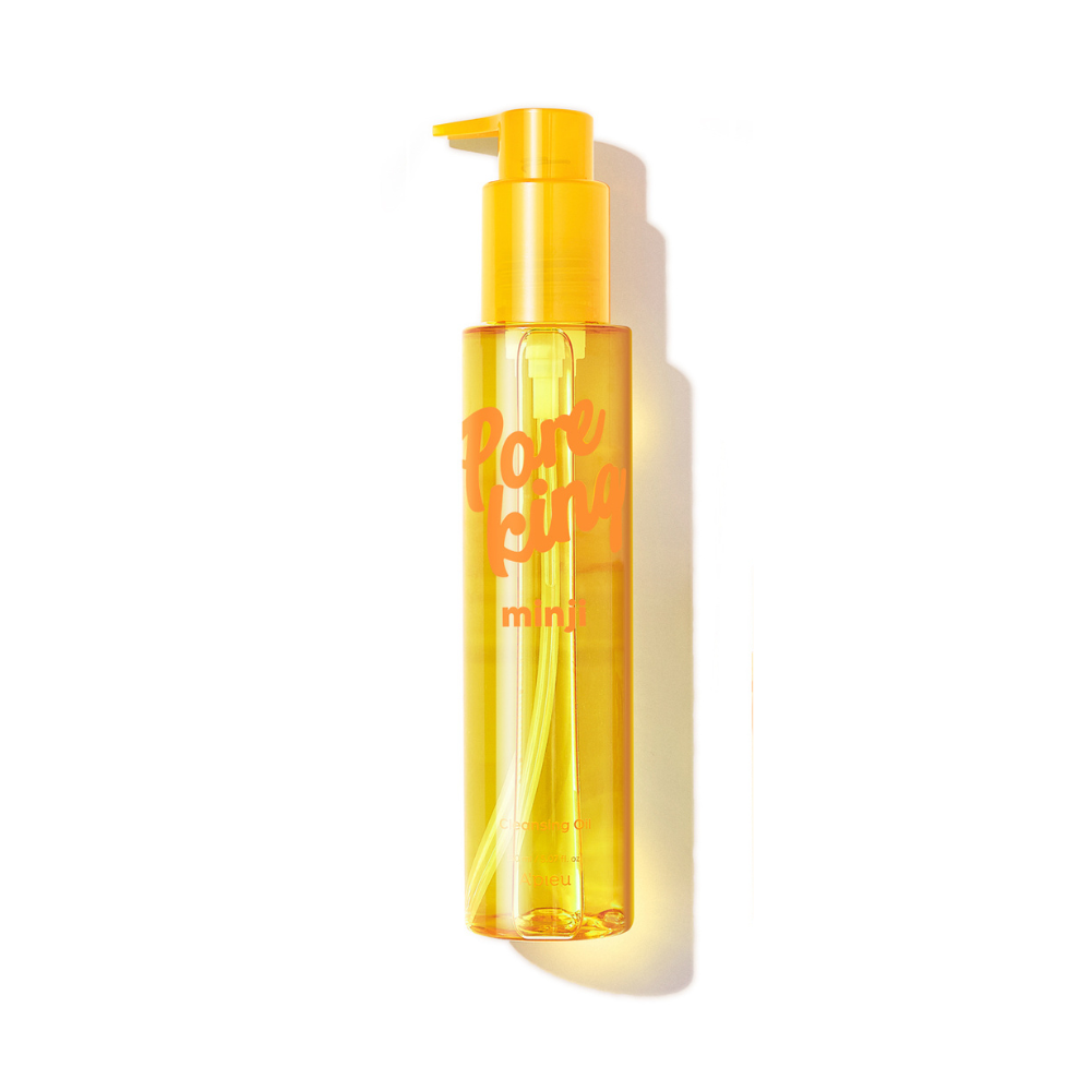 Product image of A’pieu Pore King Minji Cleansing Oil in a sleek, transparent yellow bottle with a pump dispenser. The packaging features bold orange text and a minimalist design, photographed against a clean white background with a soft shadow.