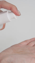 A close-up of a hand model pumping the Missha Cell Renew Snail Mucin Vitamin C Essence into their palm. The hand model then presses and lifts the fluid repeatedly to clearly show the highly viscous, stringy consistency of the snail mucin serum, emphasizing its rich, plumping, and firming effect on the skin.