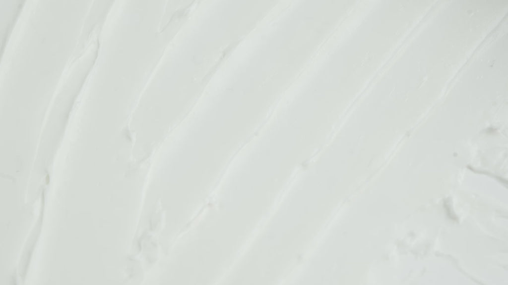 Close-up video showing streaks being made on a surface covered by the Missha Time Revolution Retinol 500IU Cream, clearly illustrating the smooth, spreadable consistency and creamy texture of this Korean skincare Retinol treatment.