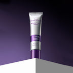 Studio shot of the Missha Time Revolution Retinol 500IU Cream in a silver tube with a deep purple cap, standing upright on a white block against a gradient purple background, emphasizing its sophisticated anti-aging skincare benefits.