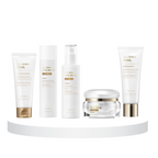 A collection of skincare products including a foaming cleanser, a-toner, an essence, a cream, and a sleeping mask, all enriched with snail mucin, displayed on a white platform against a white background.