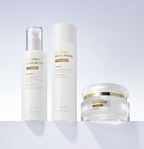 Display of the complete Missha Cell Renew Snail Mucin Vitamin C skincare line: the Ampoule/Essence, the Toner, and the Cream. The products are placed on a sleek white shelf, promoting a full anti-aging and skin brightening regimen.