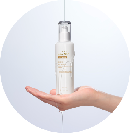 A hand holds a bottle of herbal essence with water cascading over it, set against a soft, white background.