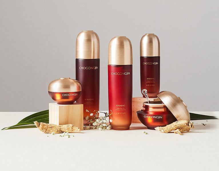 Skincare products in elegant jars and bottles with gold accents, styled with natural elements on a neutral backdrop.