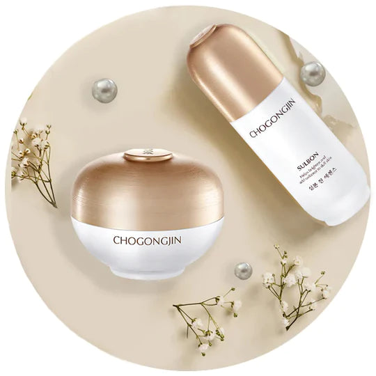 Two skincare products with gold accents on a white backdrop: one sleek bottle and one spherical jar, minimalist style.