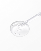 Close-up of a clear serum droplet with visible air bubbles and a glass dropper, showcasing the lightweight, hydrating texture of the skincare product.