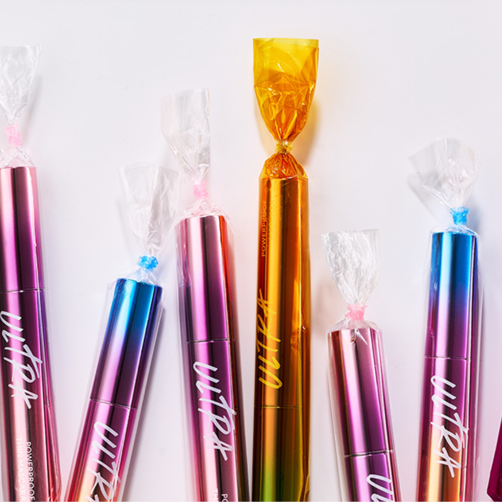 MISSHA Ultra Powerproof Thin Mascara lineup featuring holographic tubes wrapped like colorful candy for playful presentation