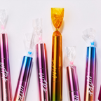 MISSHA Ultra Powerproof Thin Mascara lineup featuring holographic tubes wrapped like colorful candy for playful presentation