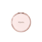 Studio shot of the closed A'pieu Cushion Foundation compact in a round, sheer pink case, ideal for natural skin tone and a dewy finish.