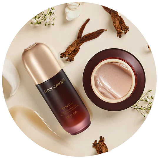 Chogongjin serum and cream elegantly displayed with herbs and flowers on a neutral backdrop for a refined look.