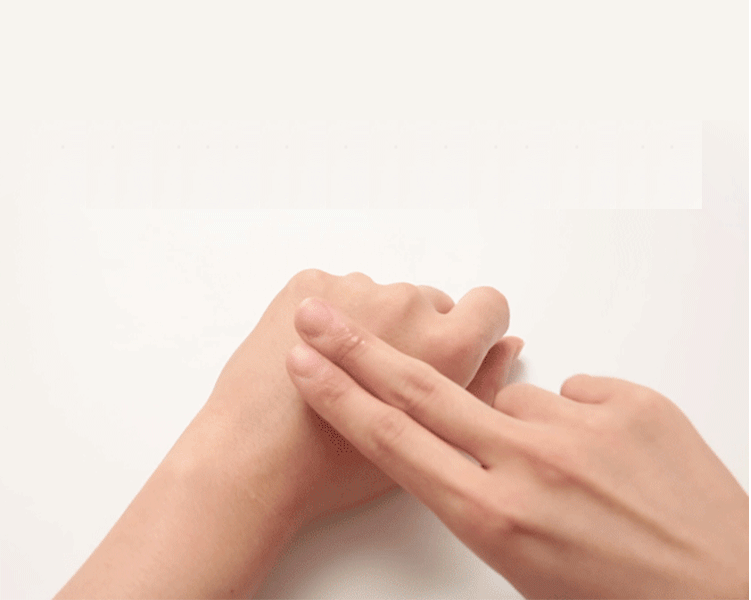 Woman rubbing gel onto hand.